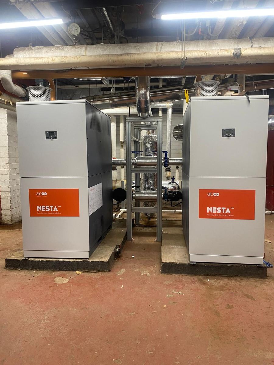 Pair of commercial condensing boilers with header pipework