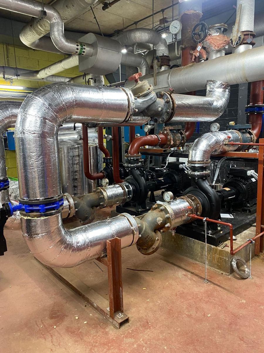 Insulated heating pipework, pumps and valves on a mechanical installation