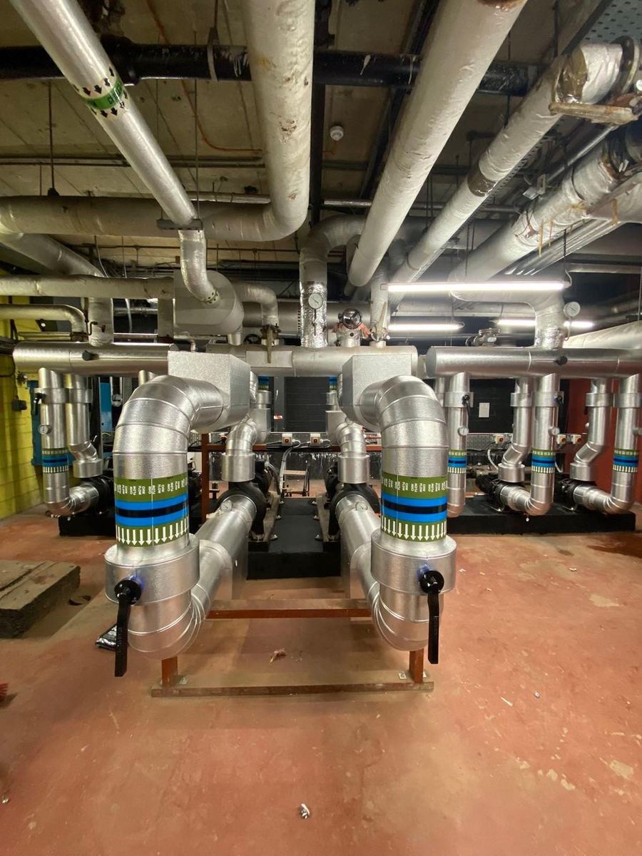 Pumps and stainless headers on a plant room installation