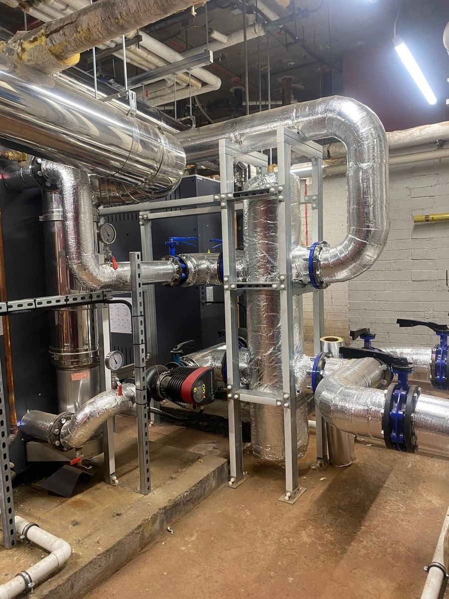 Insulated heating pipework running to a plate heat exchanger